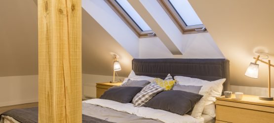 Marital bed at the attic with bedside cabinet